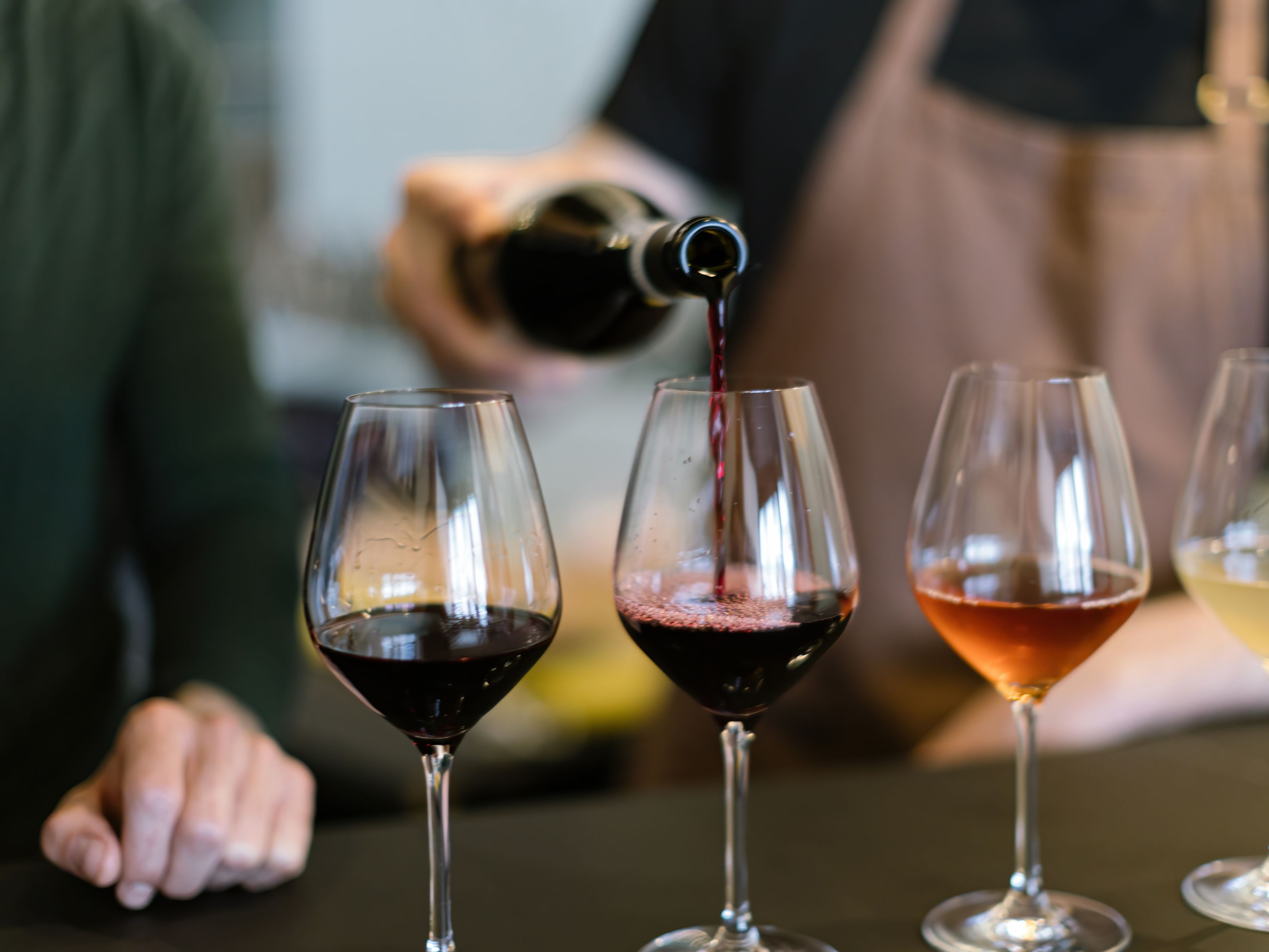 wine tasting - wine being poured into glasses